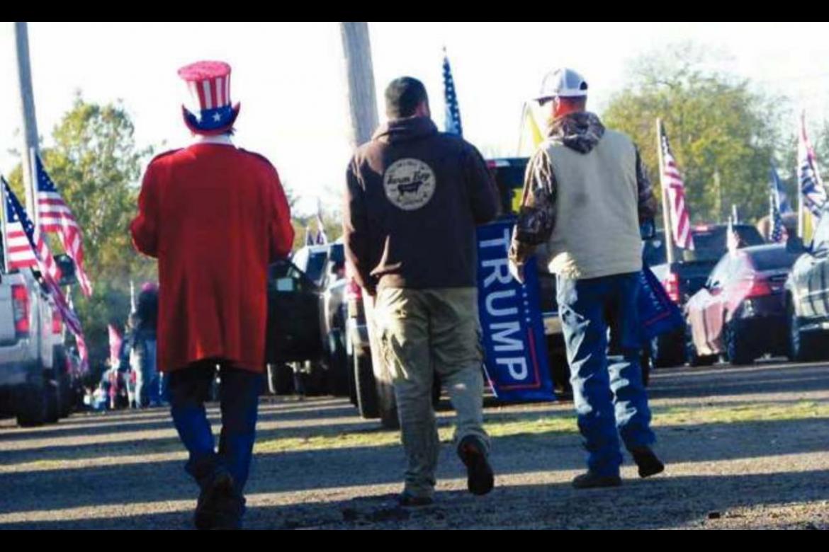 A MAN DRESSED as Uncle Sam walks with two other parade participants at the Hugo Agriplex on Oct. 31 prior to rolling out as part of a Trump train. Photo Courtesy / Sonya Campbell