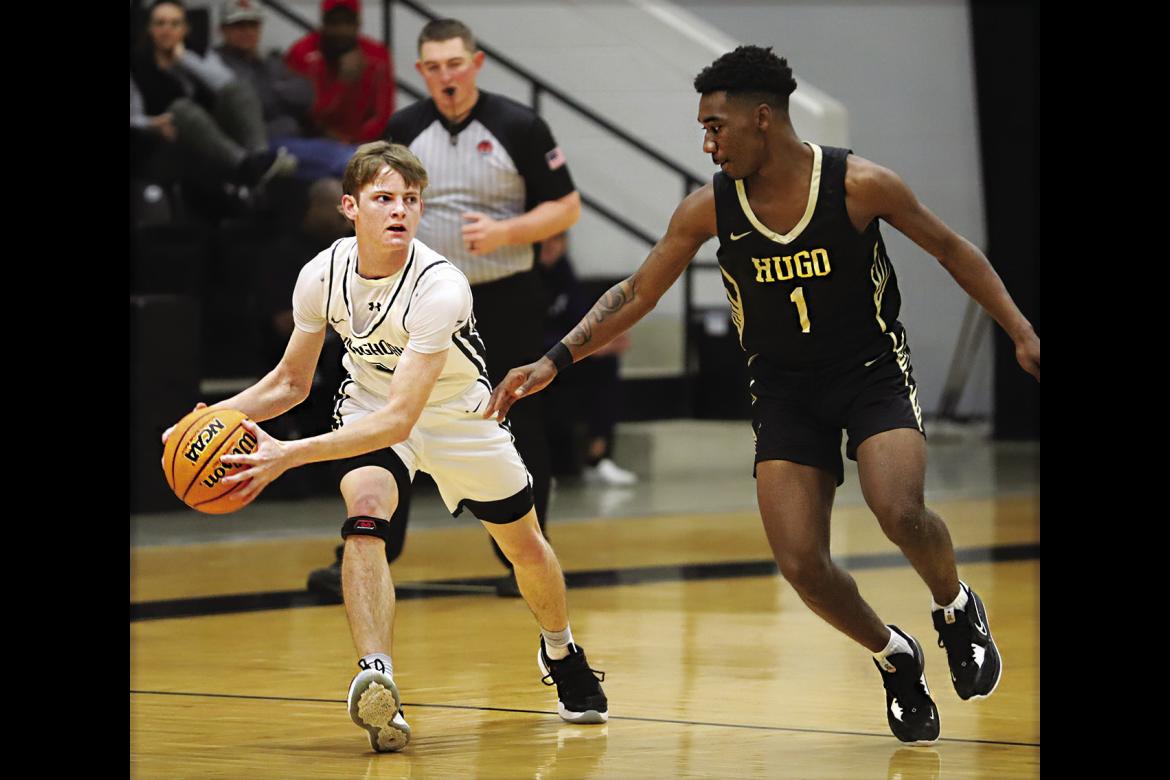 JAMARION BROWN puts defensive pressure on a Lone Grove guard during the Regional basketball tournament last week in Lone Grove. The Buffaloes defeated Lone Grove but fell to Purcell in a close game Saturday. Hugo will face Okmulgee Thursday in Ada. Hugo News Photo / Kelli Stacy