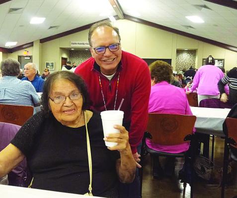 Chocta w Nat ion of Oklahoma Chief Gary Batton assists Hugo resident Marrietta Battiest by providing her ice tea at Perry Thompson’s Annual Wild Onion Dinner at Choctaw Community Center in Hugo on Tuesday evening, April 21. Contributed Photo