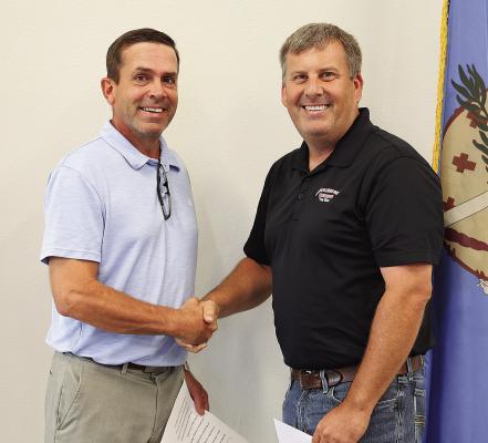 Board President Ernie Taylor (left) and Bobby Long (right) during the swearing-in ceremony for Long on Aug. 12.