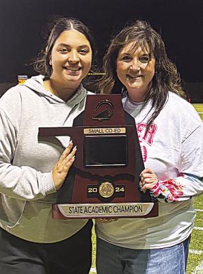 Assistant Coach Alexis McLemore and Head Coach Angie Citty display the trophy awarded at the Oklahoma Secondary School Activities Association State Championship for academic achievement. The squad also placed fourth in the state for performance in the small co-ed division. ”I’m lucky that I stepped into a program this year full of welltrained athletes,” Citty said. “They had a taste of success from last year and wanted more this year.”