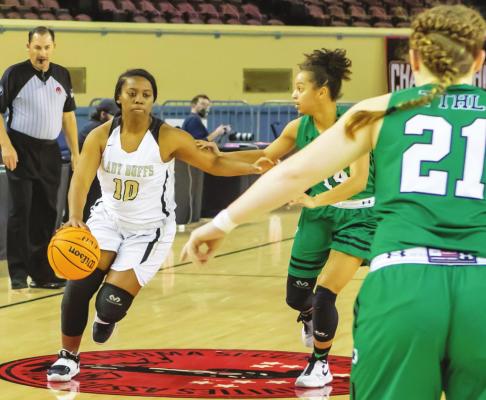 KELCIA COOK takes the basketball to challenge the defensive seams in the Jones Lady Longhorn defense during State 3A tournament quarterfinal action last week. No. 2 Jones’ powerful offense was more than Hugo could defend in the 66-33 battle.