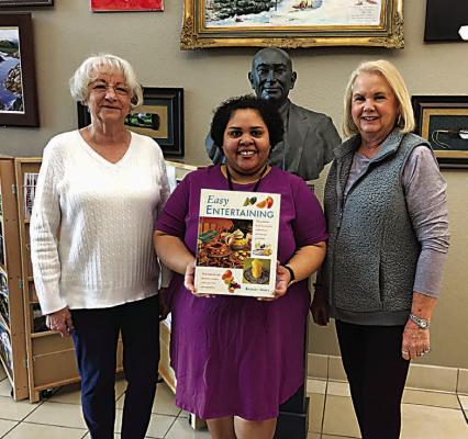 Iris Garden Club presented a book to the Choctaw County Library, as one of their yearly projects. Pictured are Donna Colgin (left) and Harolynn Wofford (right) with librarian Bessie Black (center).