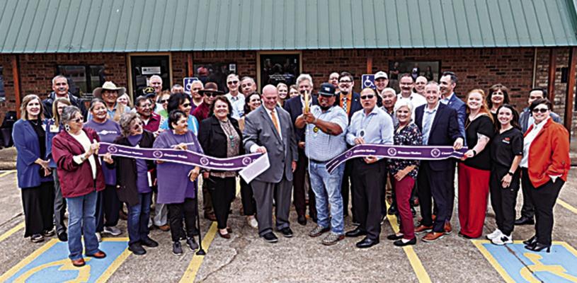 Choctaw Tribal Counc il Member for District 7, Joey Tom cuts the ribbon with OSU Medicine staff, Choctaw Nation staff, and members of the Antlers community.