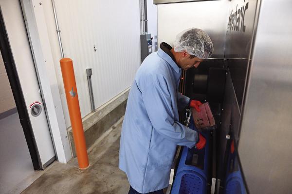 Shade Hughes, Food Agricultural Products Center High-pressure Processing manager, demonstrates FAPC’s Hiperbaric 55 high-pressure processing system. Photo Courtesy / APC/OSU Agriculture
