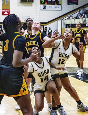 LADY BUFFALOES Schvynasti Starlin aand Kayla Minter battle underneath the goal for a rebound during the Hugo-Madill Homecoming game last week. Madill put up an impressive 79 points to take the W. Hugo News Photo / Bobby Hamill