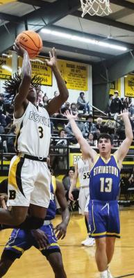 ABOVE... JERREN COOPER sails across the paint to put up two points for the Boswell Scorpions in their close game against Stringtown.