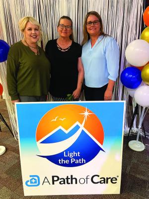 Kimberly Johnson, RN, (center) receives her award from Mary Hancock and Jennifer James. James and Johnson also accepted the Team Spirit Award for their team.