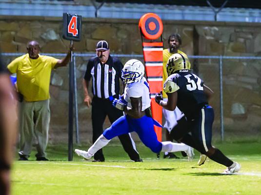 BUFFALO TEAM LEADER KORY MITCHELL, a 225-pound defensive linebacker, runs a Dixon ball carrier out of bounds after a short gain on Buff Parker Field Friday in Hugo. The Buffalo defense gave up touchdowns in the last three quarters to suffer a twopoint, opening season loss. Hugo News Photo / Bobby Hamill
