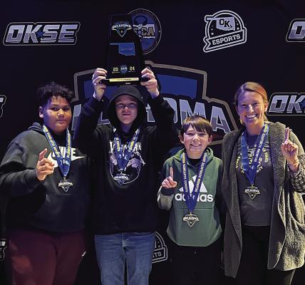 HMS State Champions who competed Dec. 6 include (l to r): Jacorey Foreman (seventh), Owen Heady (eighth), Zachary McDaniel (eighth) and coach Taylor Perry.