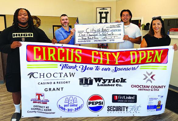 THE BIG PAYOFF! — Pickleball Tournament Director A.J. Thompson and volunteers Donte Shanklin and Bobbie Thompson were all smiles as they presented Hugo City Manager Justin Suddeth with the proceeds of the recent Circus City Open. The tournament was so successful plans for a fall tournament are already underway. Photo Contributed