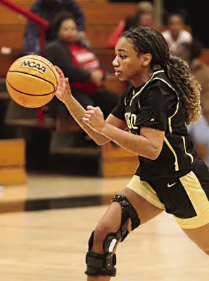 ALIVIA HOLIDAY hustles the ball down the court for the Hugo Lady Buffaloes during one of their games in the Idabel Invitational. Hugo News Photo / Kelli Stacy