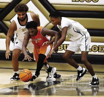 BUFFALO SQUEEZE — Hugo Buffalo senior, Aden “Fuzz” Parish teammed up with freshman Quincy Shelton last week, to put the squeeze defense on this Tulsa KIPP player. Wherever the Buffaloes play, opposing teams have come to know that DEFENSE is one of Coach Shanklin’s benchmarks, and Buffalo basketballers seldom do not live up to that reputation. Hugo News Photo / Kelli Stacy