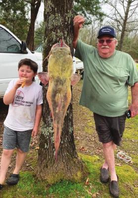 ABOVE: Earl Blagg Austin Potter and his papa, Ron Potter III, proudly pose next to the 54-pound catfish they caught on a jugline at Hugo Lake.