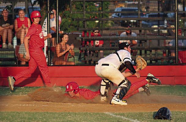 SOPER’S LEVI BAILEY SCORES and watches as teammate Dallin Gilbert slides safely in to home plate ahead of the throw for two big runs for the Soper Red Bears in recent baseball action. Brian Moore Photo