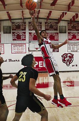 BACK ON THE HARDWOOD! With the holiday break officially over, area basketball teams will be returning to their regular season schedules this week. Above, Soper’s Denny Stacy goes up for two points in a recent game against Fort Towson. Defending for the Tigers was Daeyon Payun. Brian Moore Photo