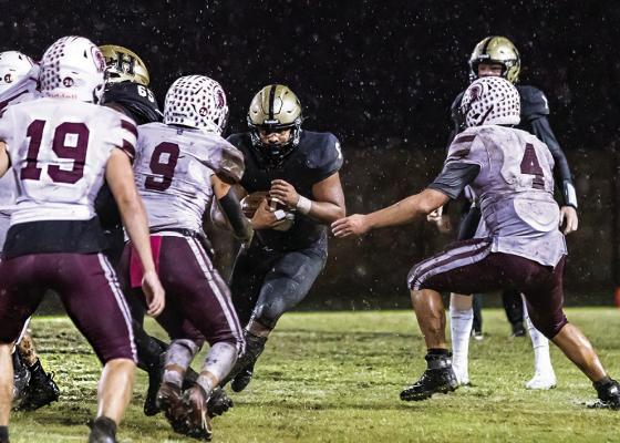 HUGO’s MOST PRODUCTIVE running back, Aden “Fuzz” Parish, was unable to break away from team tackles by the Ironheads on the rain-soaked turf of Buff Parker Field. Hugo News Photo / Bobby Hamill