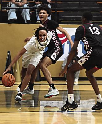 JUWAN JOHNSON pushes the basketball down the baseline and makes a sharp pass to a teammate under the bucket for two Hugo Buffalo points against Texarkana.