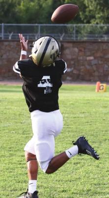TRAVION KING stretches to pull in a T.J. Frost pass during recent football action against Coalgate. King is a freshman who may see some game time returning punts for the Buffs this season. Hugo News Photo / Bobby Hamill