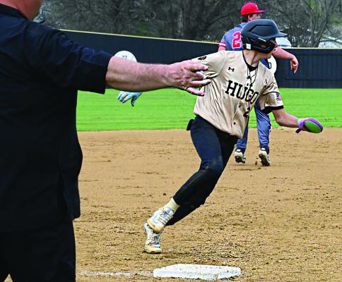 HUGO BUFFALO FRESHMAN JACE BAKER gets the “take it home” signal from Head Coach Scott Schier and rounds third to score for the Hugo Buffaloes in their big home field win over Tishomingo. Hugo News Photo / Stan Stamper