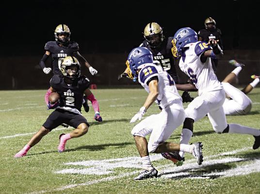TRAVION KING plants his foot and cuts up the field after catching a pass from Buffalo QB Jayka Santillan. Antlers defenders Zane RInehart and Daniel Caldwell bear down on him on the left side of the Bearcat defense to hold him to a short gain. Hugo News Photo / Kelli Stacy