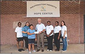 ITC Local Government and Community Affairs Regional Manager Kim Goodnight presents a check to support Project G.A.I.N. and the launch of their new youth program. Pictured: Mehlenie Adamson, Zandria Brownfield, Celia Brownfield, Kim Goodnight, Ri’Khel Jones, Tiffany Mitchell and Michelle Factor.