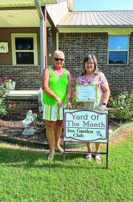 Iris Garden Club’s Yard of the Month was awarded to Gail and Shane Allen on Deer Run Rd. The beautifully maintained yard features trees, crepe myrtle’s, roses, zinnias and more. Pictured are Iris Garden Club representative Harolynn Wofford and Gail Allen.