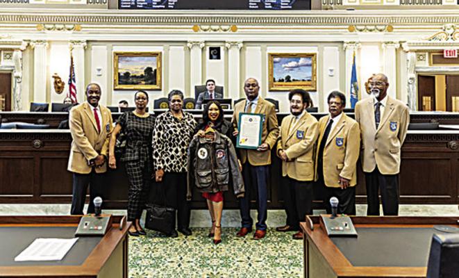 Pictured are: President Mahlon Smith, Kelli Hall Jones, Sherri L Harris, Representative Ajay Pittman with the military jacket of Tuskegee Airmen Mr. Edward Woodard, Sr., Curtis Blunt, Karl Wilburn, Duboise Gooden, and Floyd Gordan.