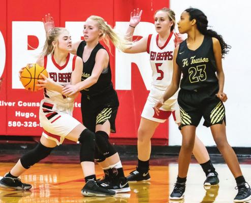 SOPER’s EMILY WEBB looks to pass the ball to teammate DeStiny Goodman as Fort Towson’s Summer Lowrance applies defensive pressure and her teammate Kyria McGee slides into assist. Soper’s 17-point third quarter offensively was enough to edge ahead of the Lady Tigers and ice the win. Hugo News Photos / Bobby Hamill