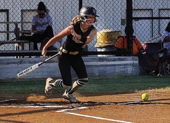 DESTINEY CHUMLEY lays down a near-perfect bunt for the Fort Towson Lady Tigers and makes her dash for first base during Highway 70 rival softball action last week. Hugo News Photo / Brian Moore