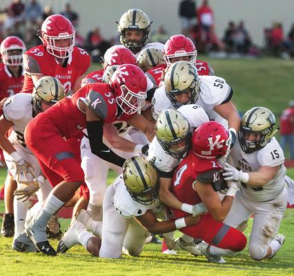 Buffalo Defense swarms runner... BUFFALO GANG TACKLE — Demonstrating that Hugo’s defense still thinks it can battle with anybody, a host of Hugo defenders gang-tackle a Kingston ball carrier. Pictured above are Tony Perry, Aden Parish, Caleb Joe, Lige White, Jace Moffitt, Chance Marzek and Kris Akins. Hugo News Photo / Bobby Hamill