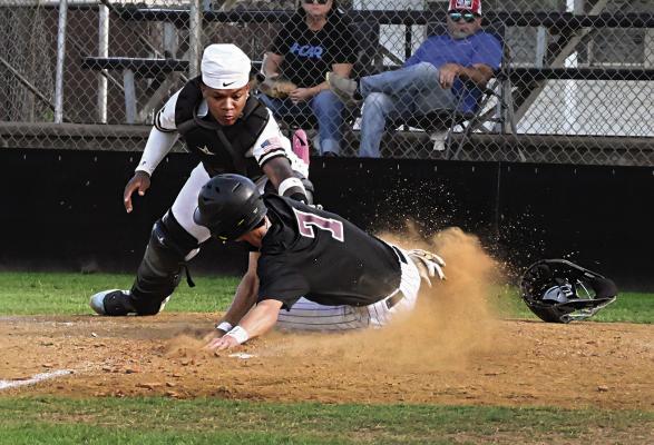 HUGO BUFFALO CATCHER JA’MARI SCROGGINS takes the throw to home and puts the tag on the sliding Atoka Wampus Cat base runner. Behind the plate the umpire yells... “YOU’RE OUT!” Hugo News Photo / Stan Stamper
