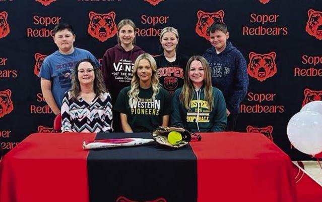 SOPER’S SHY’ANNE WOLFE signed her letter of intent last week to play softball for Western Oklahoma State College in Altus. The high school senior is the daughter of Ginger and Mike Potter. She is pictured with (front row l to r): Ginger Potter and Tatum Fancher; back row (l to r): Austin Potter, Clacie Marsh, Kaylea Potter and Easton Potter. Also coaches Mark Hammock and Brandon Debo (not pictured).