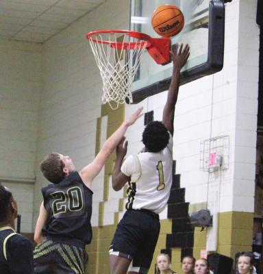 KEVIN WALLACE takes the ball to the rack for two points against the Broken Bow Saveages in HMS eighth-grade action last week. Hugo posted a comfortable 37-27 win. Hugo News Photo / Stan Stamper