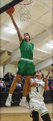 CANYON JAMES soars up to the rim for two points as Hector Smith defends for the Tigers.