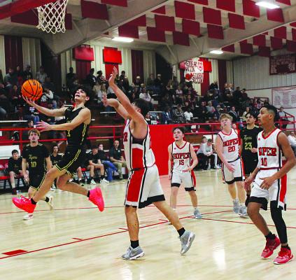 ALLEN HUTCHINSON glides through the paint to put up two points for the Fort Towson Tigers during recent basketball action against the Red Bears of Soper. Brian Moore Photo