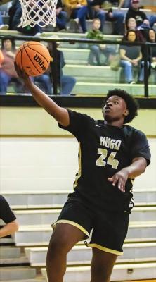 DONTE’ SHANKLIN cruises through the paint on the fast break to put up two points for the Hugo Buffaloes during recent baskeball action. The Buffs are away at the Henryetta Tournament, Silo and Broken Bow before returning to Simon Parker Gymnasium on Jan 29. Hugo News Photo / Bobby Hamill