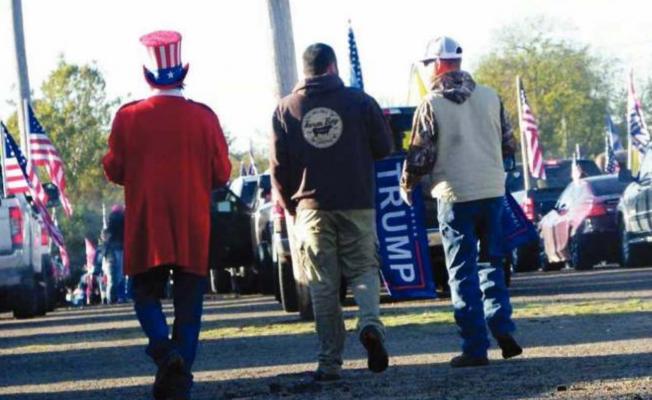 A MAN DRESSED as Uncle Sam walks with two other parade participants at the Hugo Agriplex on Oct. 31 prior to rolling out as part of a Trump train. Photo Courtesy / Sonya Campbell