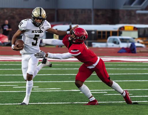 HUGO’S MOST TALENTED running back, LaMarcus Davis turns the corner and stiff-arms an Idabel Warrior defender for a nice gain in last Friday’s first District clash of the season for Hugo. The Buffaloes are at home this Friday against Wilburton. Hugo News Photo / Bobby Hamill