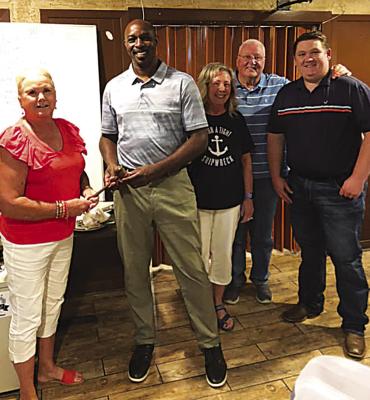 The Hugo Lions Club held its installation of new officers for the upcoming year. Pictured is President Harolynn Wofford passing the gavel to incoming president Chris Scott. Also pictured are Vice-President Susan Brewer, Lion Tamer Mike Brewer, and Treasurer Royce Chandler.