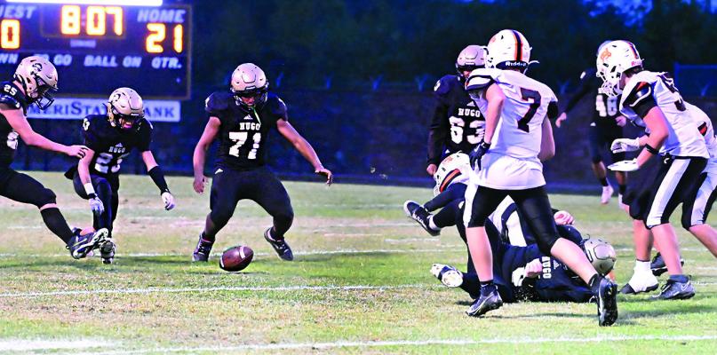 FUMBLE! — After one of their Buffalo teammates knocked the football out of the hands of a Roland ball carrier, these three Hugo Buffaloes had the opportunity to pounce on the loose ball for a fumble recovery. When the dust settled, it was No. 23, C.J. Ward who came out of the pile with the ball in hand. HUGO NEWS PHOTO / Stan Stamper