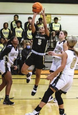 ASHIA JORDAN finds a seam in the Broken Bow defense and puts up two of her 10 points for the Lady Buffaloes in their win against the Lady Savages last week.