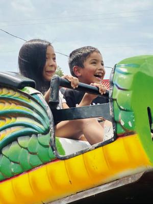 Olivia Martinez, 8-year-old third grader and her brother Benjamin Gilley, 5-year-old kindergartener at Hugo Elementary School, enjoy the Annual Choctaw Nation Festival in Tuskahoma, Okla. Photo Courtesy / Darrel James