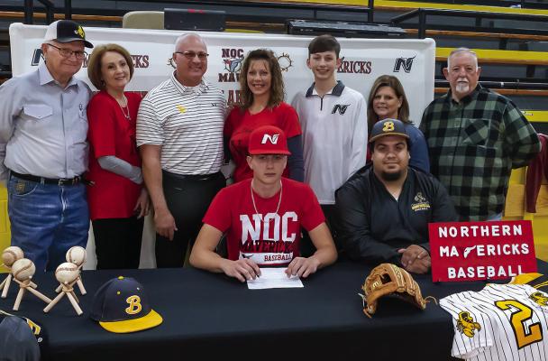 KAMDEN EDGE was joined last week at Boswell by family, friends and teammates as he accepted a scholarship offer to play baseball for the Northern Oklahoma Mavericks. Pictured above with Kamden are: (l-r) Mac Edge, Sharon Edge, Keith Edge, Kylee Edge, Kolson Edge, Karen Griffith, Mike Griffith, and Coach Christian Walsdorf. Hugo News Photo / Bobby Hamill