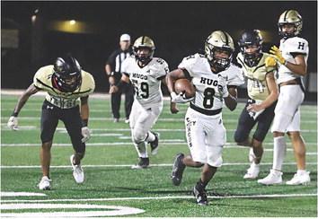 SENIOR BUFFALO Freshman Jay Scroggins showed he has plenty of heart during Friday’s clash with the Beggs Golden Demons. Above, Scroggins races around the right side of the Buffalo line for a nice gain and some valuable rushing yardage against a stingy Beggs defense. Also pictured is offensive lineman Johathan Chavez. Hugo News Photo / Kelli Stacy