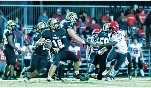 BUFFALO QUARTERBACK JAYKA SANTILLAN spots an open receiver downfield and gets set to launch a long one against the Idabel Warriors Friday in Gene Nesbit Stadium. Battling to hold back defensive aggressors are members of the Hugo O-line, including Jonathan Chavez, Jayse Trantham, Connor Frazier, Amari Wallace and DaShon Sims. Hugo News / Bobby Hamill