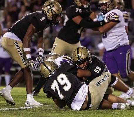 MILO RIBEIRO and JONATHAN CHAVEZ bulldog a Heavener ball carrier for a short gain with help from teammates Quincy Shelton and Keyshawn Miller. Hugo News Photo / Bobby Hamill