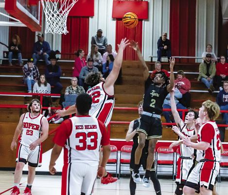 MASON MOORE checks up in the paint to put up two of his 16 points scored against the Red Bears of Soper last week, despite being surrounded by the entire Soper team. Hugo News Photo / Bobby Hamill