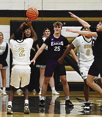 MAHKI EDWARDS checks up on the edge of the paint to put up two points for the Hugo Buffaloes in recent basketball action against the EXCEL Eagles. Edwards’ teammage Juwan Johnson is also ready to battle for a rebound if Edwards’ shot should miss. Hugo News Photo / Stan Stamper