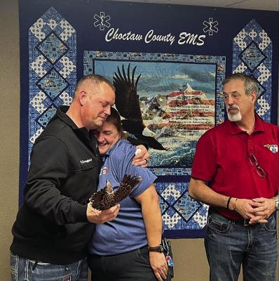 above: Choctaw County Ambulance Authority Executive Director Randy Springfield hugs Paramedic Sara Richmond on Dec. 30 when he was presented with a statewide award. Richmond nominated Springfield for the honor. Also pictured is Oklahoma EMT Association board member Kyle Pruitt. Above right: CCAA Executive Director Randy Springfield (left) and Oklahoma EMT Association board member Kyle Pruitt.